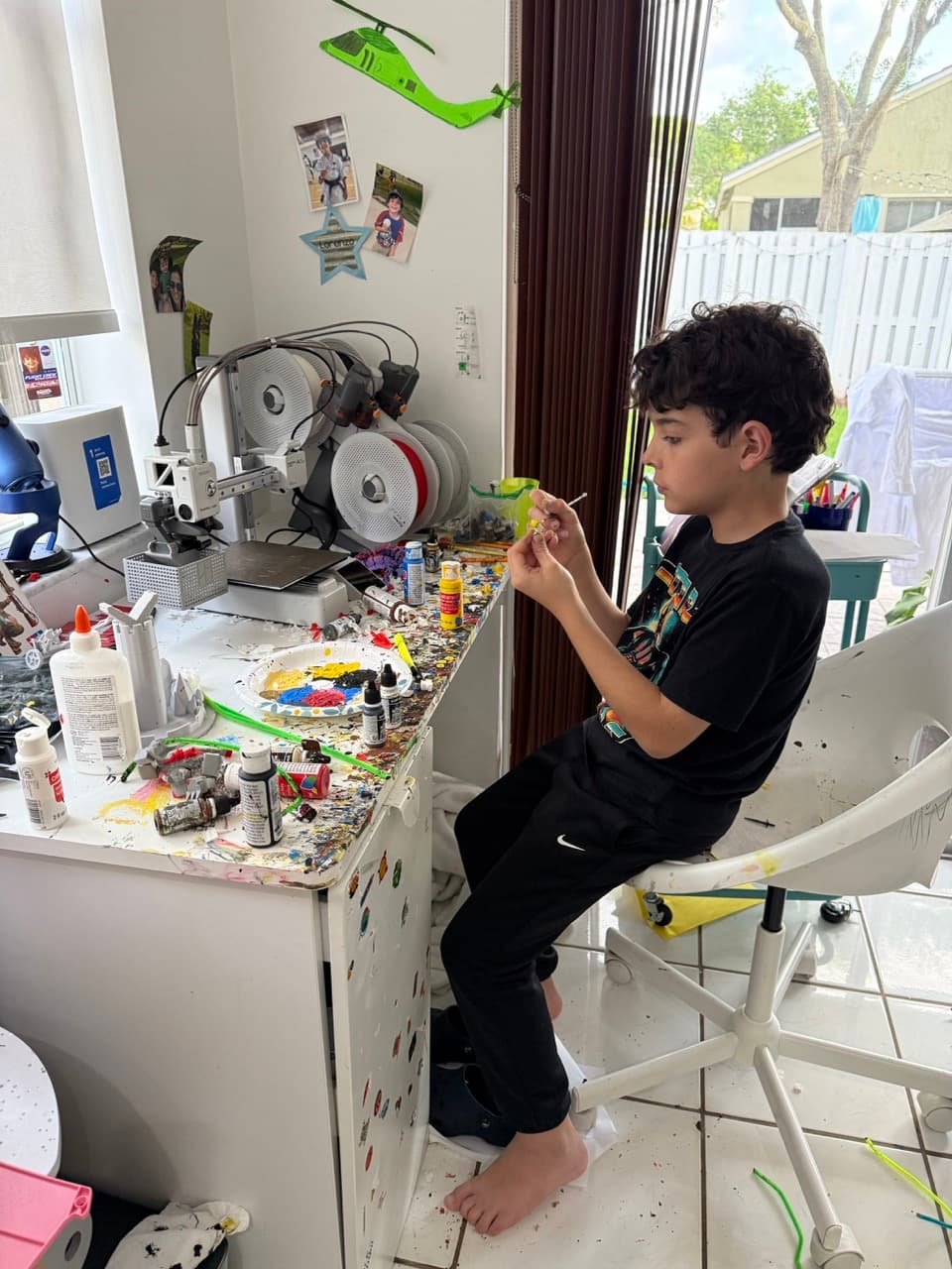 Lorenzo painting a 3D printed figurine